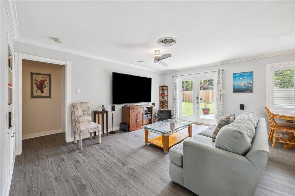 The living room opens directly to the patio and backyard through glass French doors, bringing in tons of natural light.