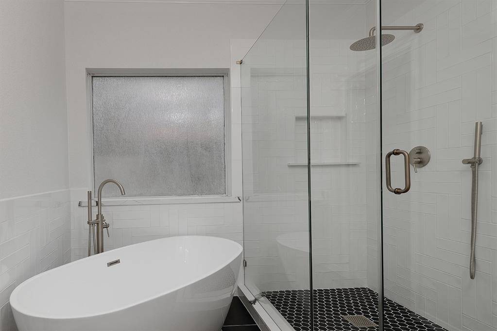 Soaking tub and custom tile shower with frameless glass