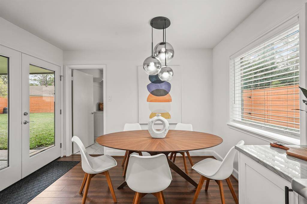 The Breakfast Room is a light-filled space featuring French Doors that open directly to the back patio, creating a seamless connection between indoor & outdoor living.