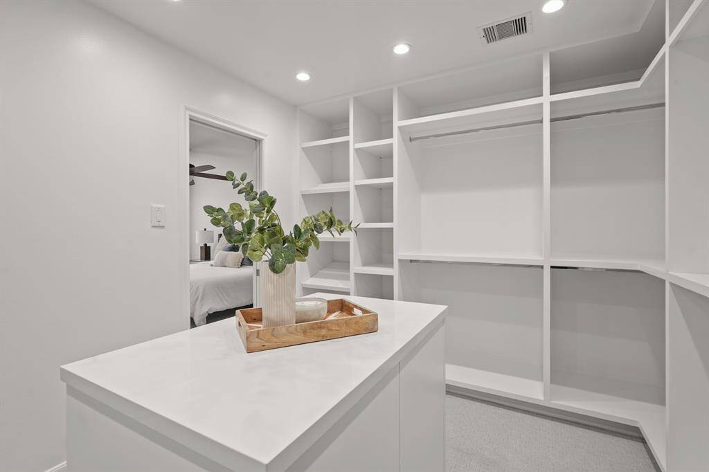 The custom closet is a luxurious addition to the Primary Suite, making it the perfect place to store your clothing & accessories. The beautiful island dresser is designed for extra storage & convenience.