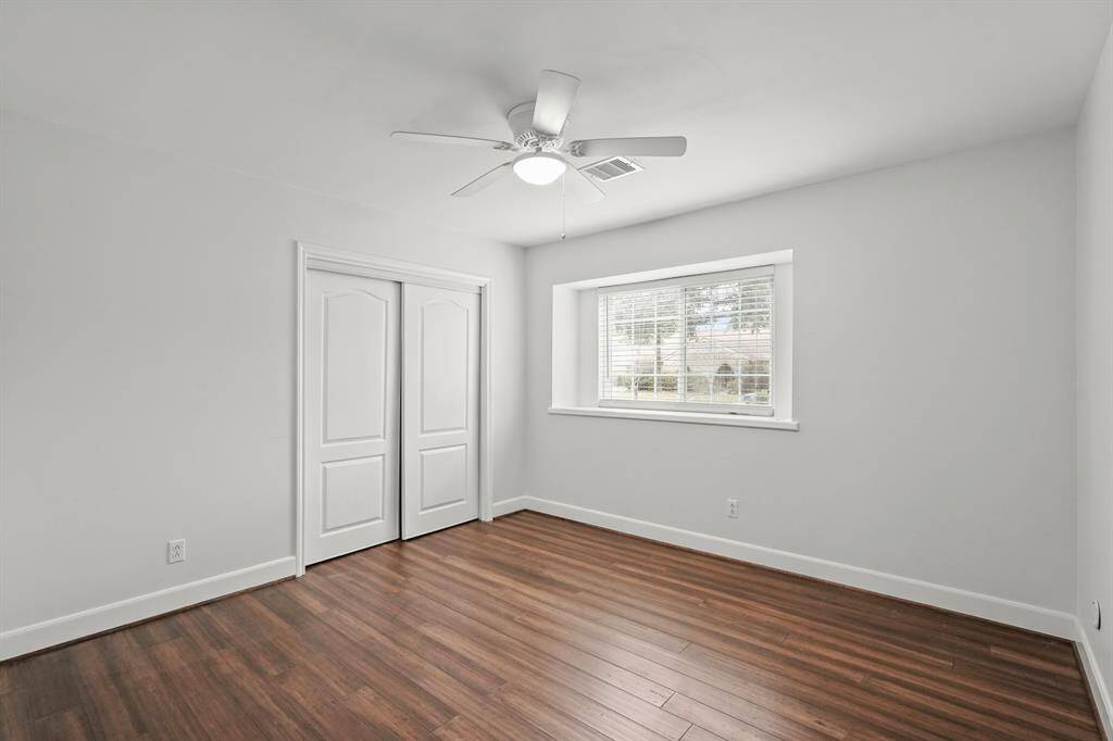 Bedroom # 2 with hardwood floors & neutral tones is light & bright & has a sizeable closet.