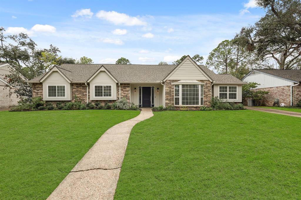 The inviting exterior is framed by vibrant greenery, creating a fresh & welcoming atmosphere.