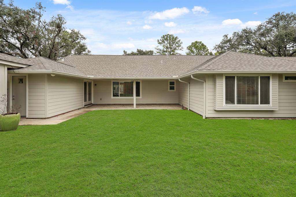 Step out into the backyard, where a generous covered patio awaits. This outdoor space is perfect for dining, relaxing with a book, or entertaining guests.