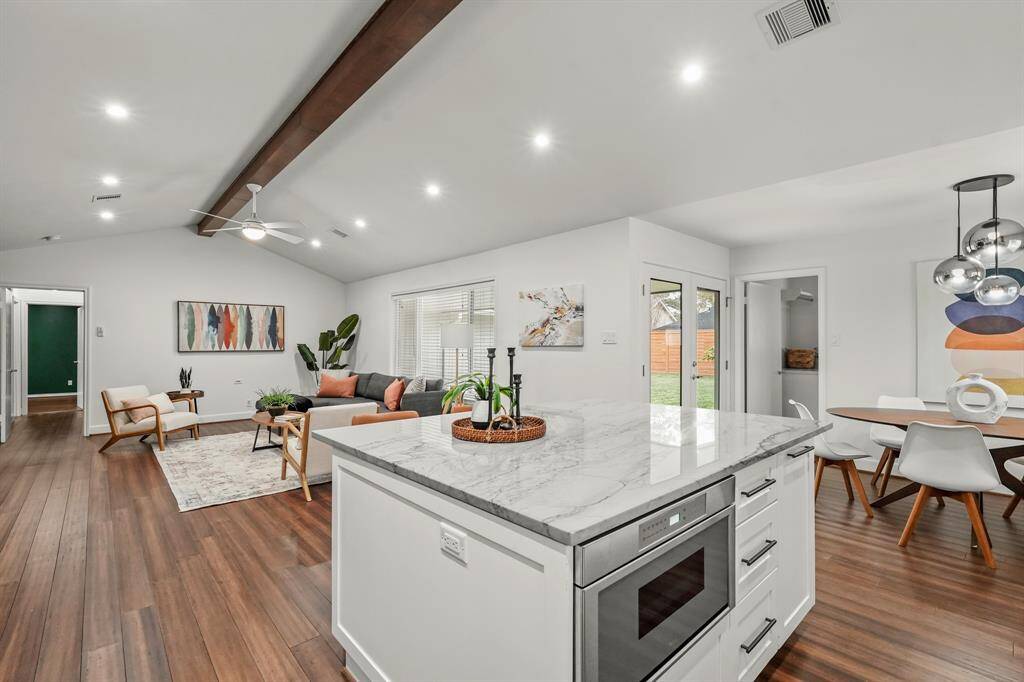 Spacious & lovely quartzite Kitchen Island acts as the centerpiece of the space, providing plenty of room for meal prep & casual dining. Plus the it features the under cabinet microwave.