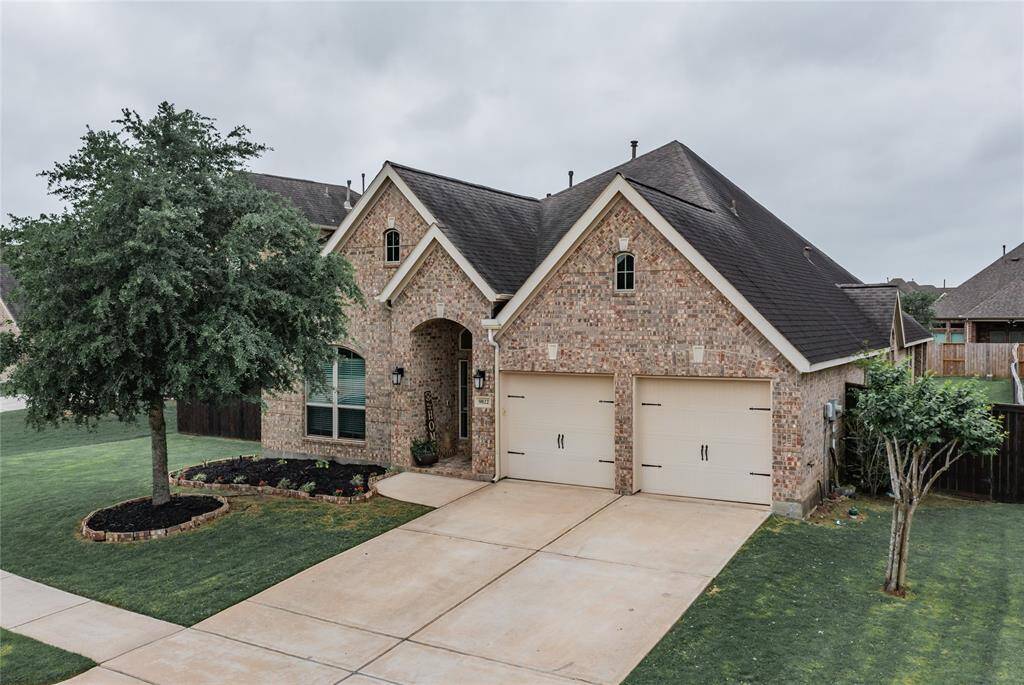 Welcome home -aerial view of this all brick exterior single story home with large back yard and hot tub