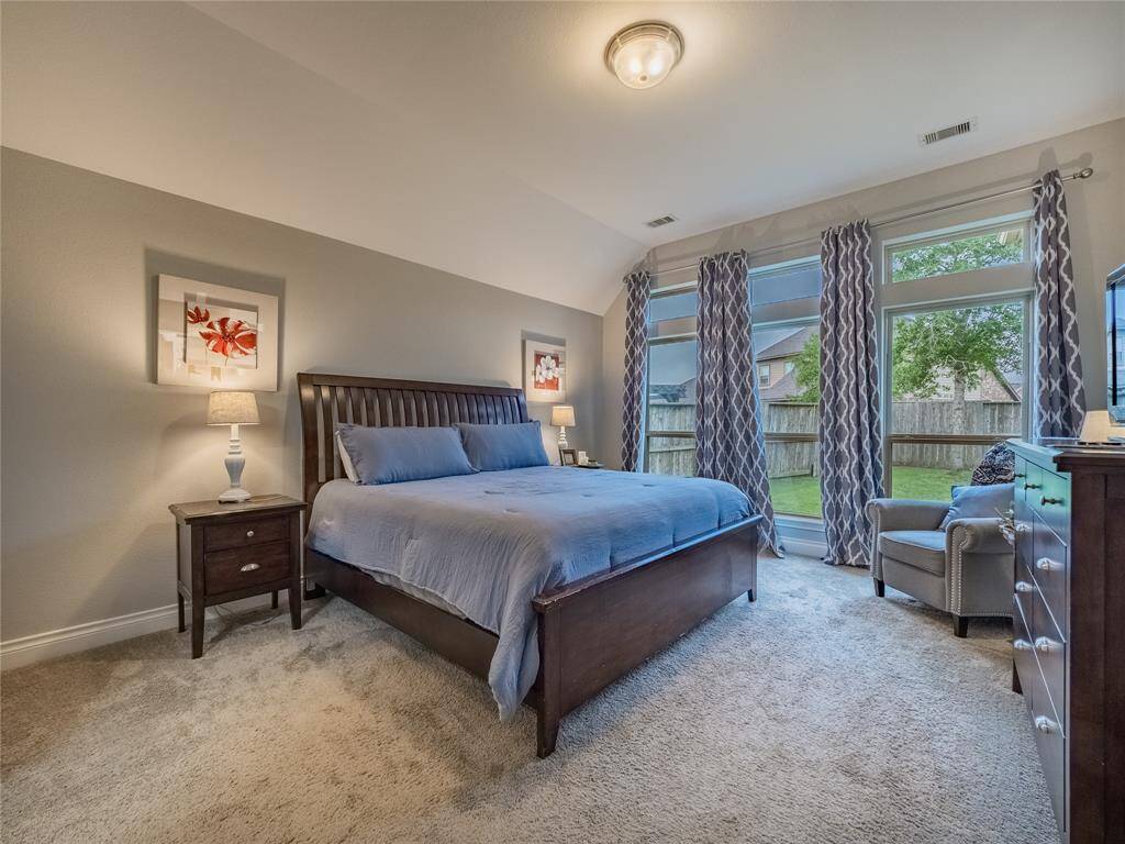 Primary bedroom is very large has large oversized windows over looking the back yard