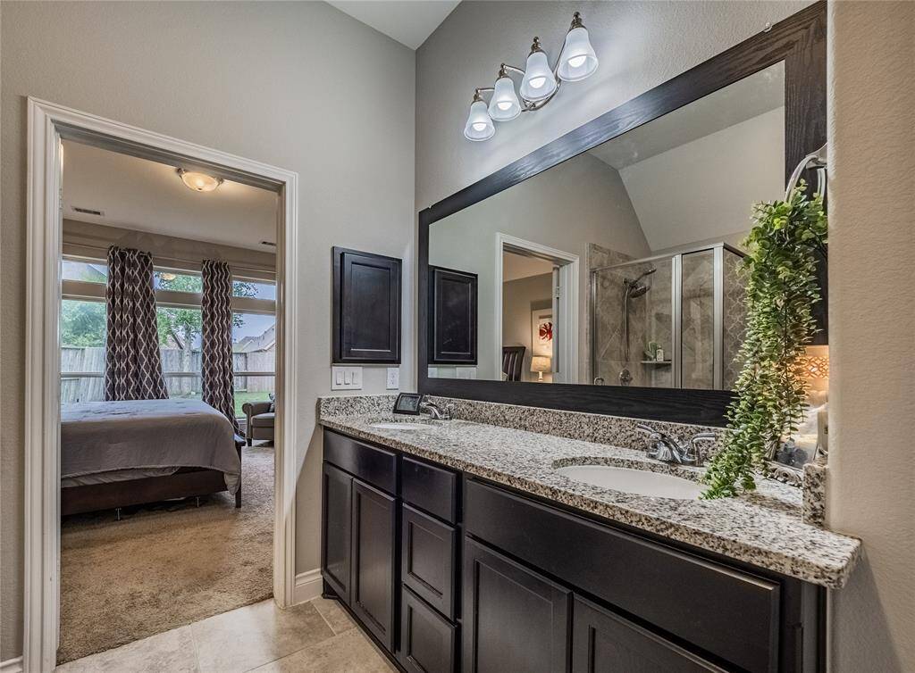 Primary bath has glass walk in shower