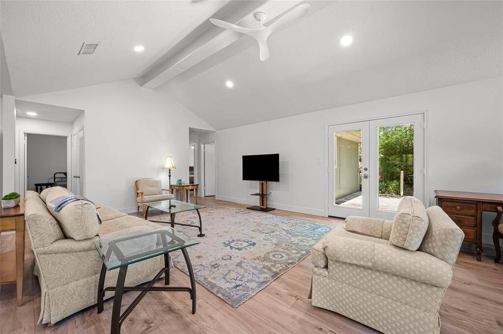 Spacious living room with neutral walls and floors.