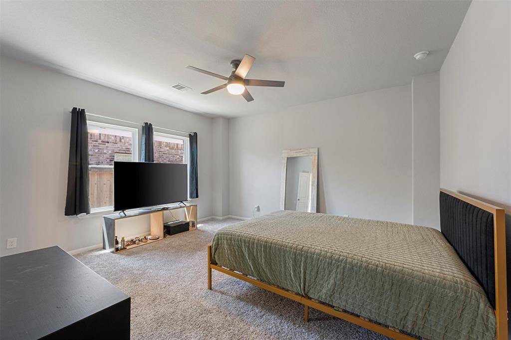 Spacious and serene primary bedroom—your perfect retreat with room for a king-sized bed, seating area, and your personal touch.