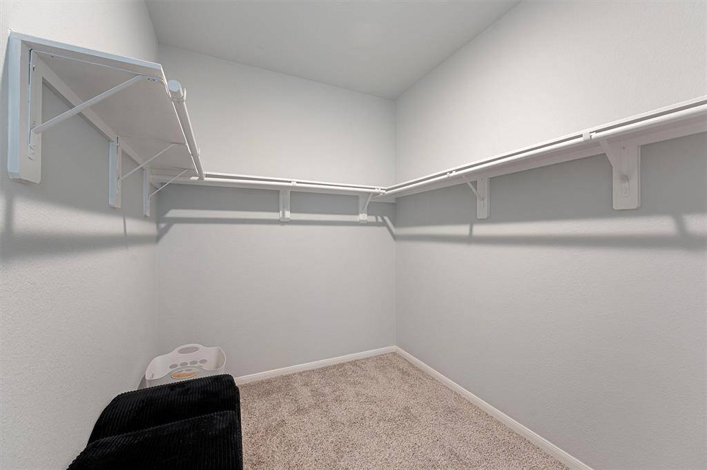 Dream-worthy walk-in closet with ample space to keep everything organized—finally, room for it all.