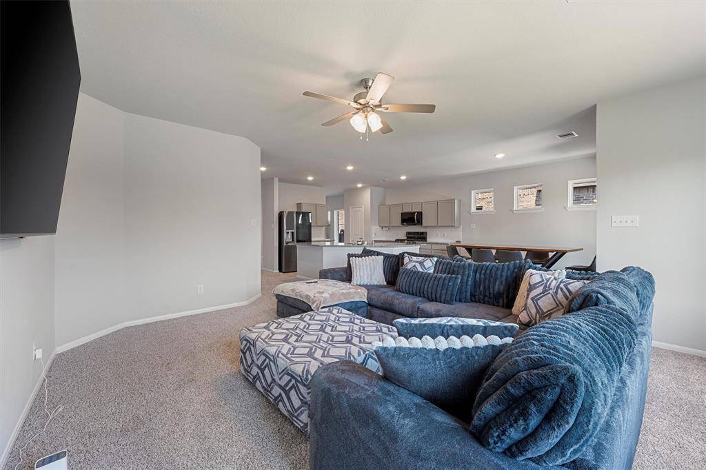 Open-concept living and kitchen area with abundant natural light, ideal for seamless everyday living and entertaining.
