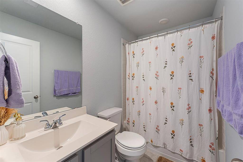 Upstairs full bathroom with a large vanity, modern fixtures, and a tub/shower combo.