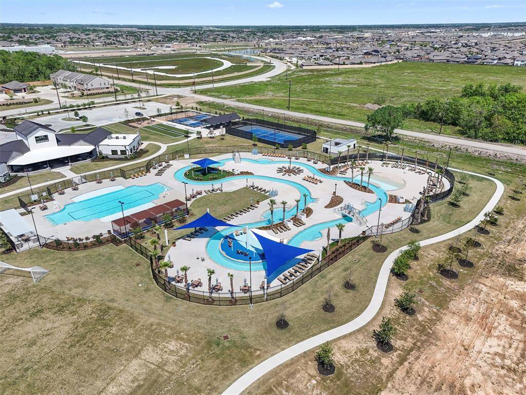 Relax and unwind at the heated lazy river, oasis pool, beach walk-in, shaded cabanas, and hammock area, offering the ultimate resort experience at home.