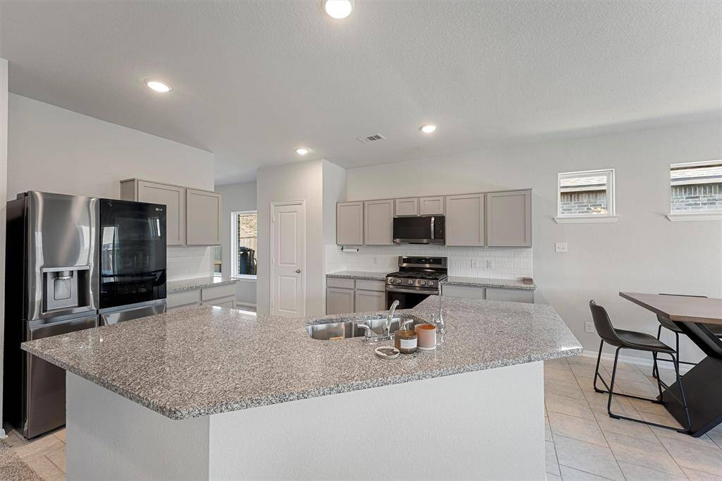 Open-concept layout connects the kitchen seamlessly to the breakfast area and living room.
