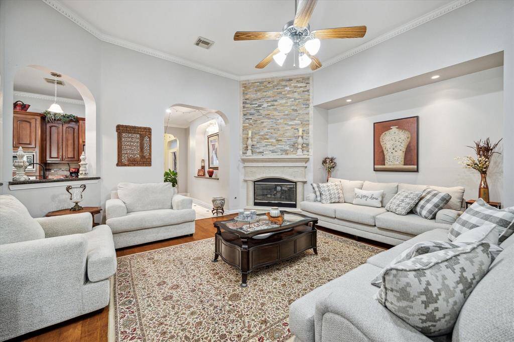 Take a look at this massive den looking into the entryway and kitchen, with a luxurious fireplace. What stories will you and yours be telling around the fire?
