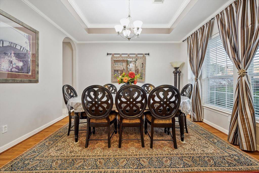 With hardwood flooring and tray ceiling with crown molding, this is a phenomenal space for gathering with loved ones around your favorite home cooked meal.