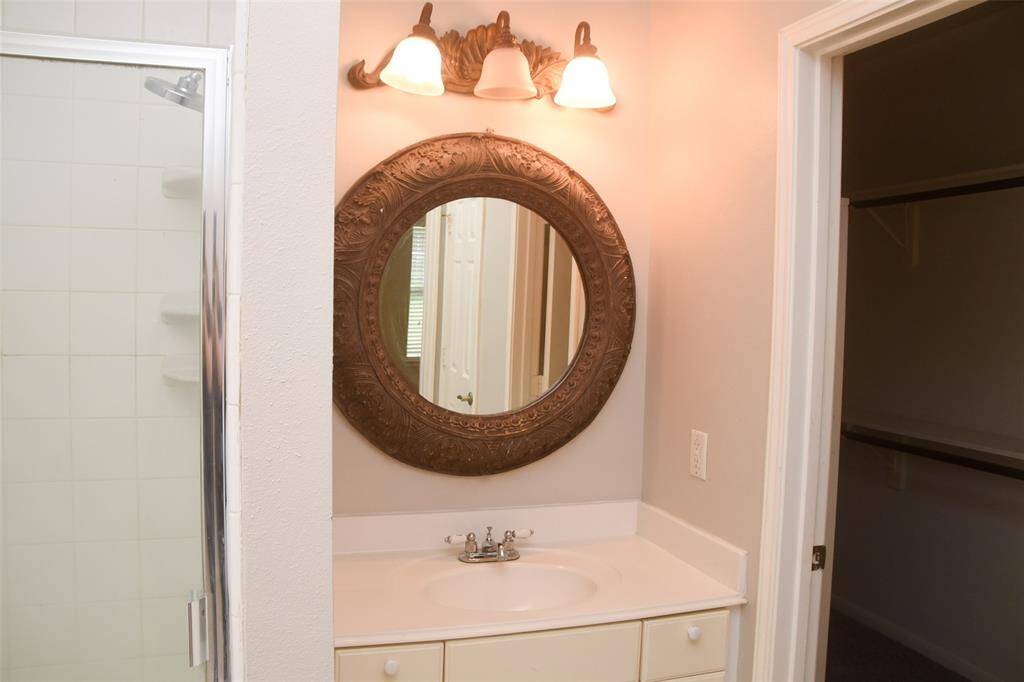 Nice sink in primary bathroom with separate shower.