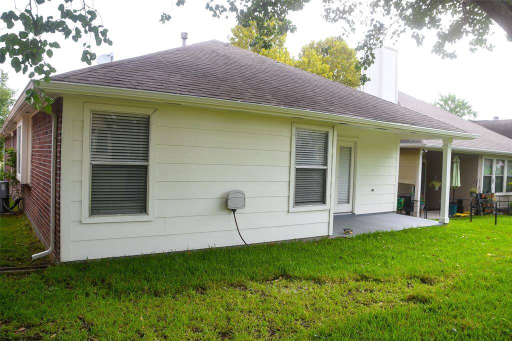 Back of the home which faces a easement and nice patio area.