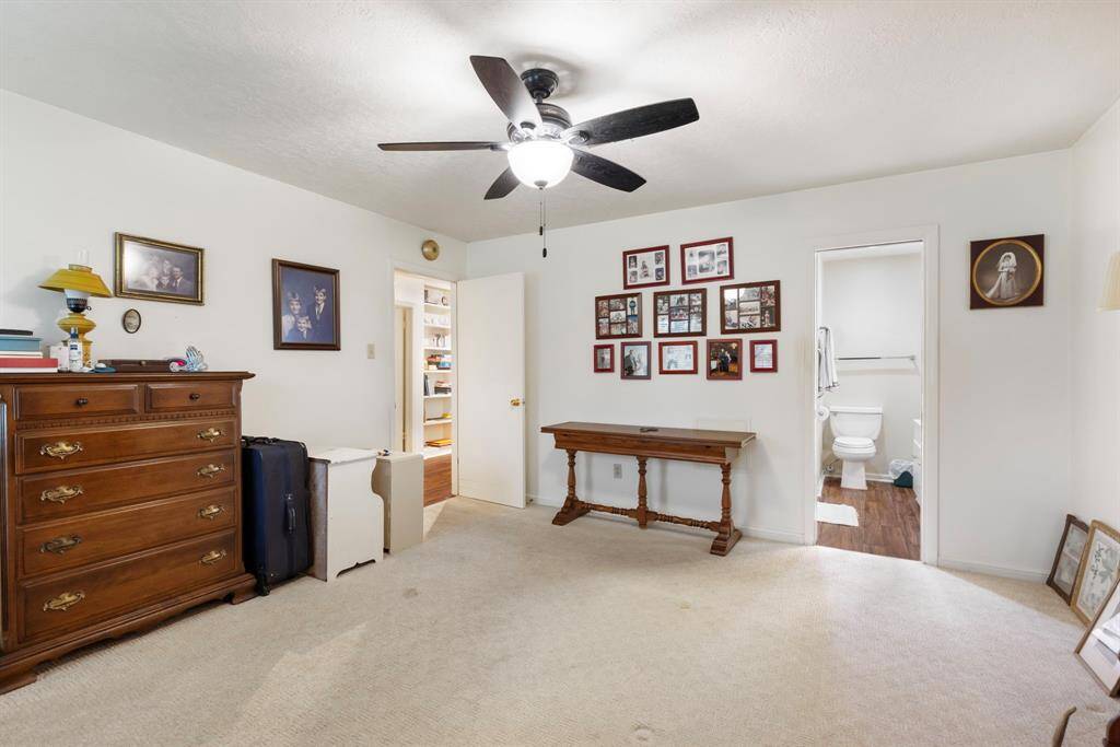The primary bedroom is currently storing extra furniture and decor.