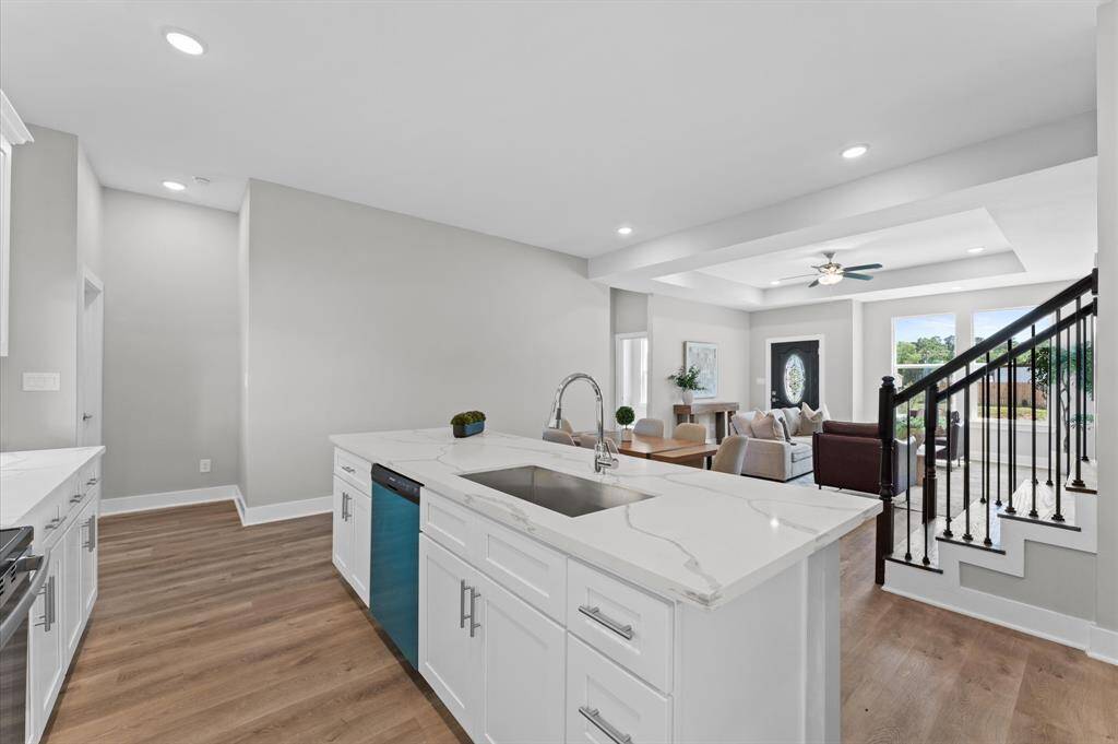 Stunning kitchen with quartz countertops, ample cabinetry, and stainless steel appliances included.