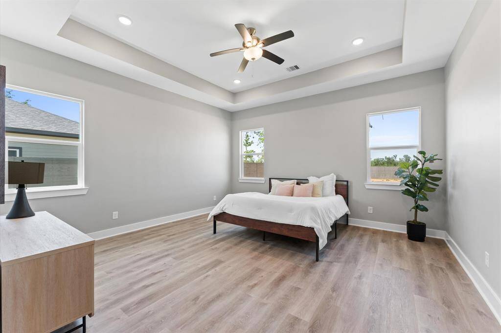 Oversized primary suite with room for a sitting area and tons of natural light.