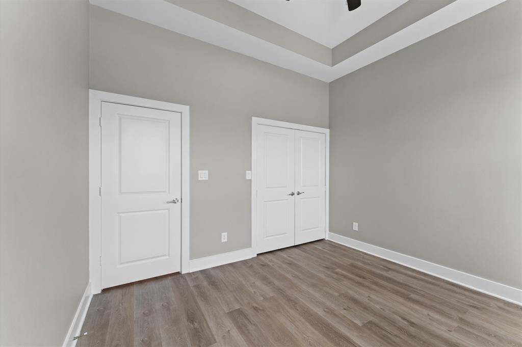 Forth bedroom with modern finishes and no carpet.