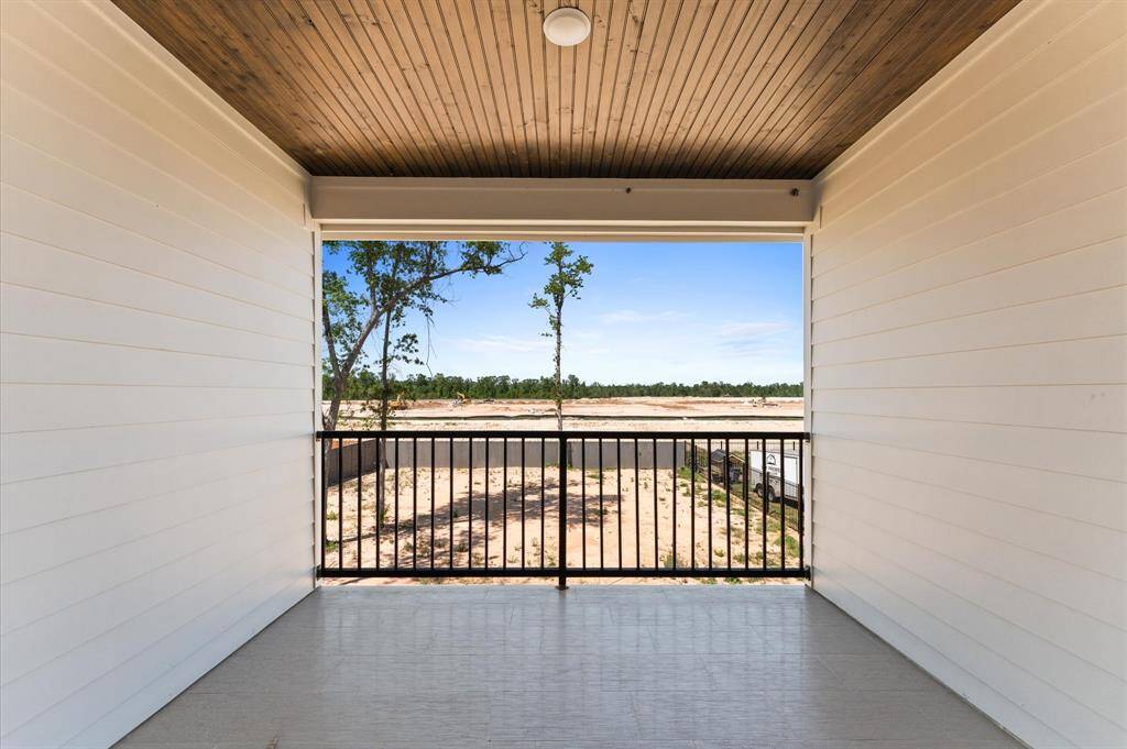 Private balcony with wood-accented ceiling and a view of the backyard—great for relaxing.