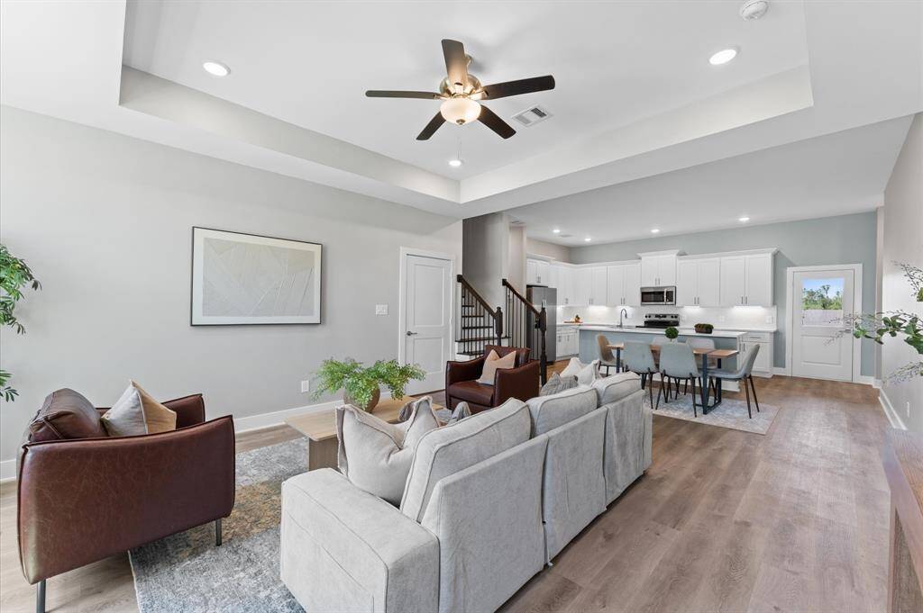 Open-concept living area featuring high ceilings, LED lighting, and plenty of natural light