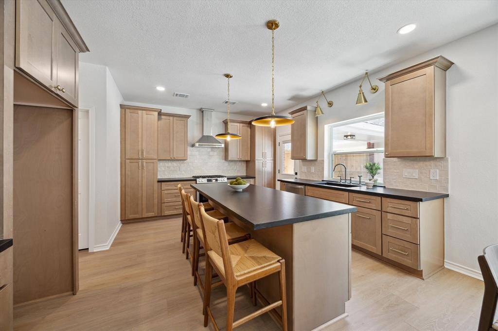 The deluxe kitchen includes rich cabinetry, tons of gorgeous counterspace, and stylish finishes.