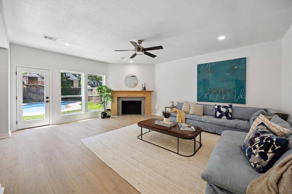 The updated fireplace anchors the inviting family room. Lots of natural light!