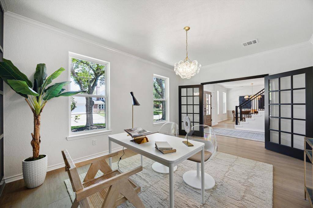 French doors offer privacy to this roomy office. Dont' miss the beautiful lighting!