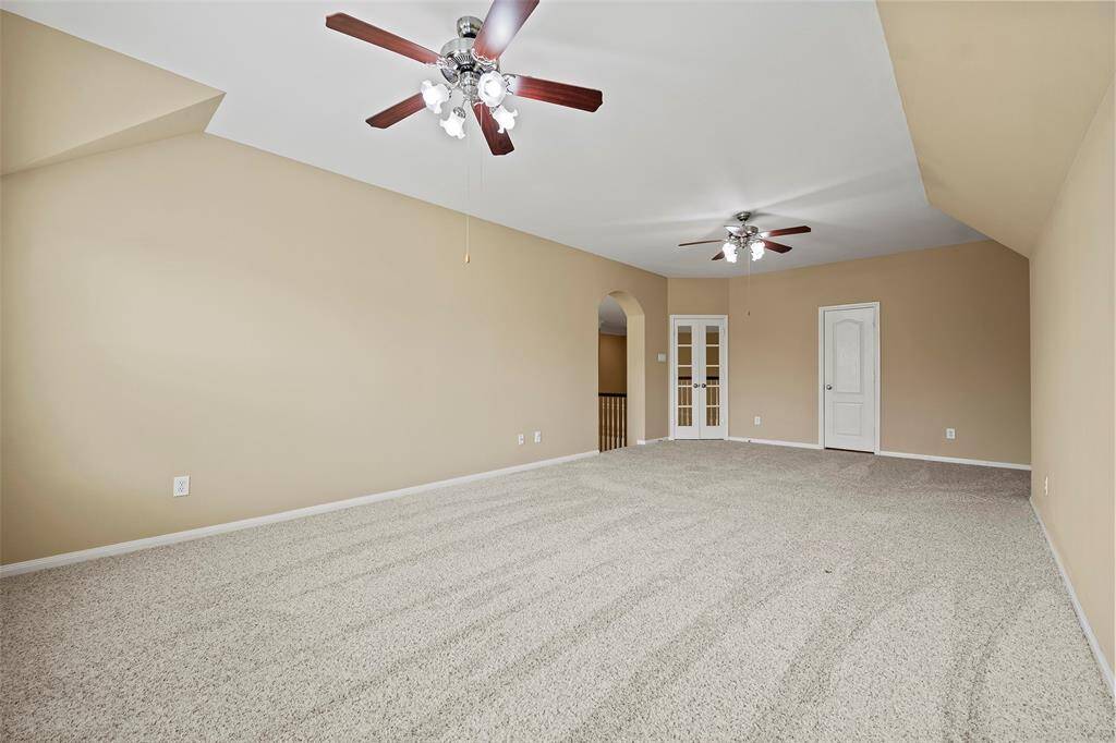 Another view of the second-floor game room with abundant natural light. It has a half bathroom conveniently located alongside it.