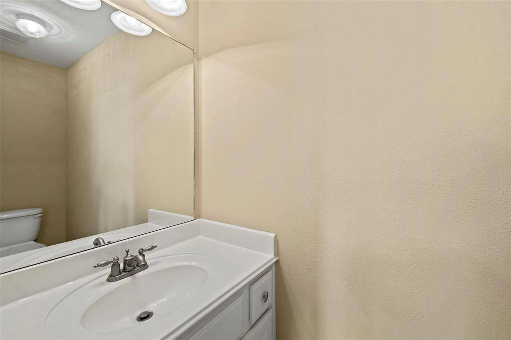 The second half bathroom adjacent to the game room. The lighting is recessed, providing a clean and bright look.