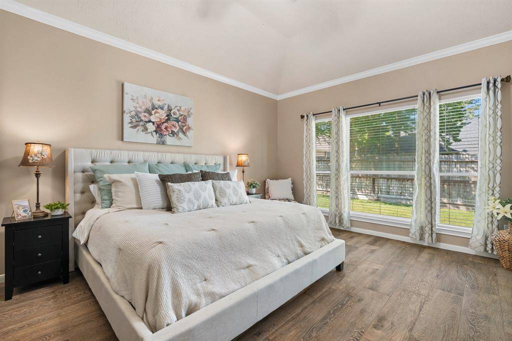 Spacious primary sweet with soaring ceilings.