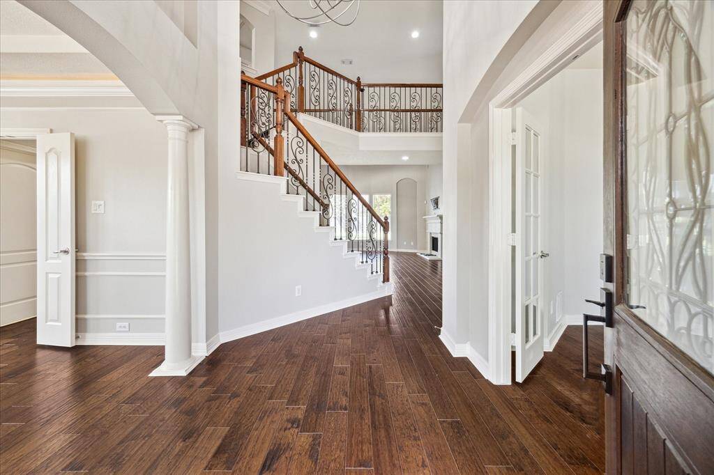 Wrought iron staircase & hardwood floors throughout