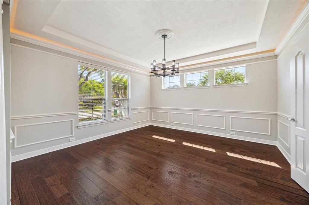 Casually elegant dining room w coffered ceilings, lighting & crown molding