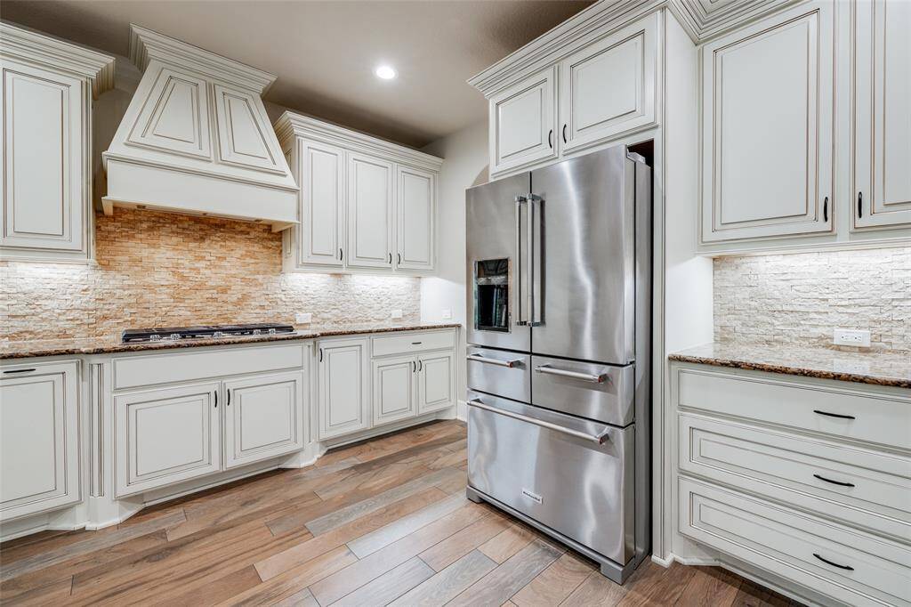 Stainless steel KitchenAid refrigerator included.