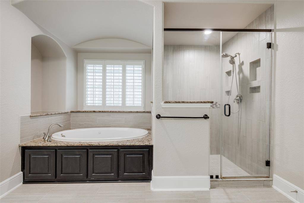 Primary on-suite whirlpool tub and separate shower.