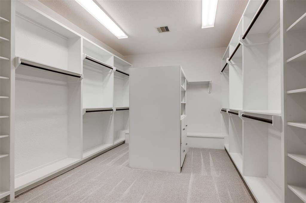 The primary bedroom walk-in closet with built-ins.