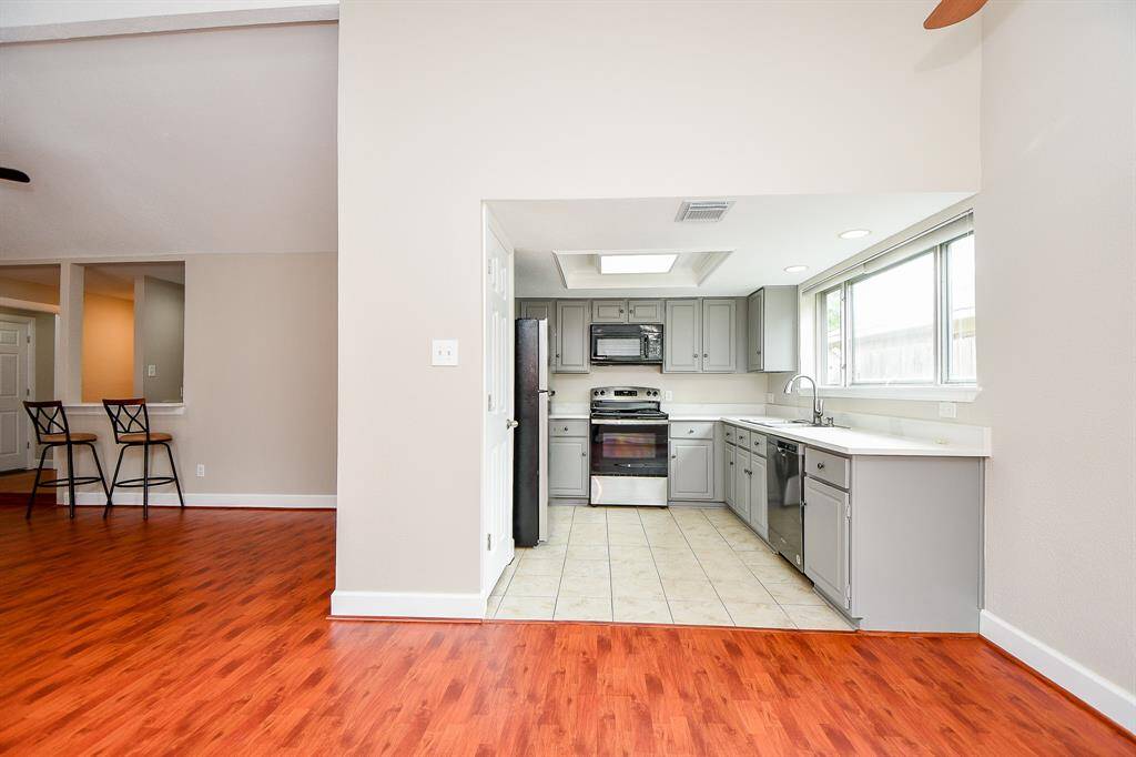 Light and bright cook's kitchen with ample quartz counter tops and cabinets