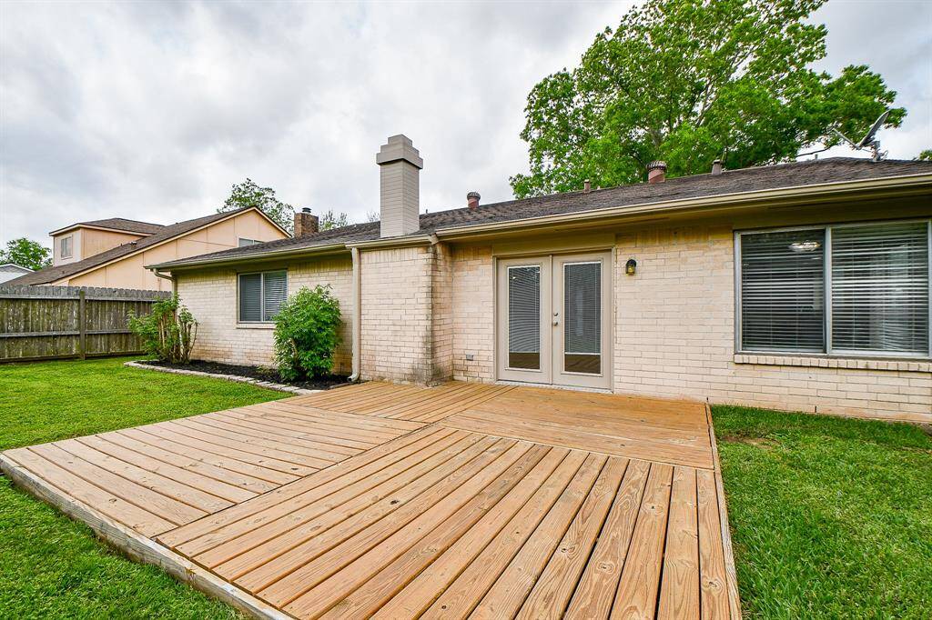 Back of home with deck. Replaced surface planks & coated against UV ray damage