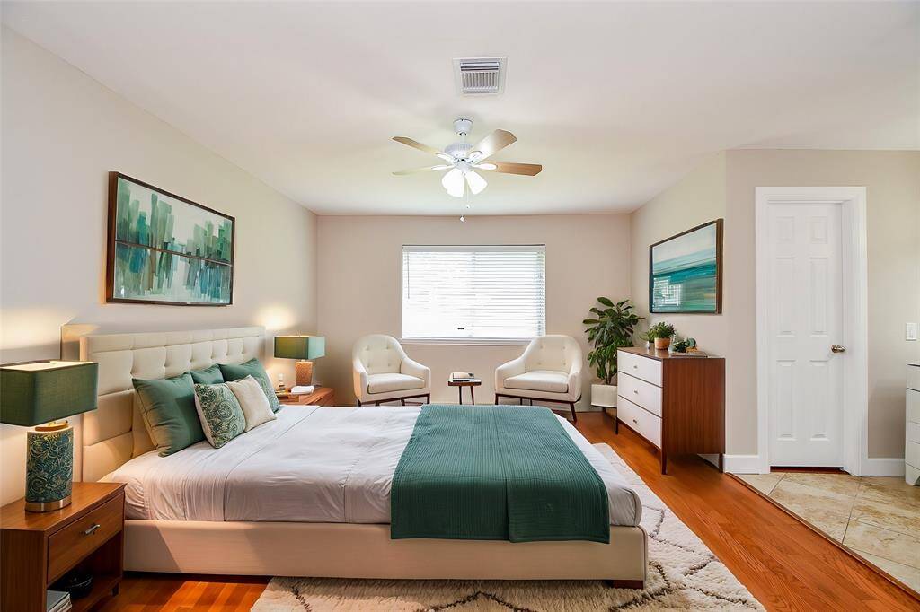 Primary bedroom is a quiet retreat. Other bedrooms are on the other side of the home