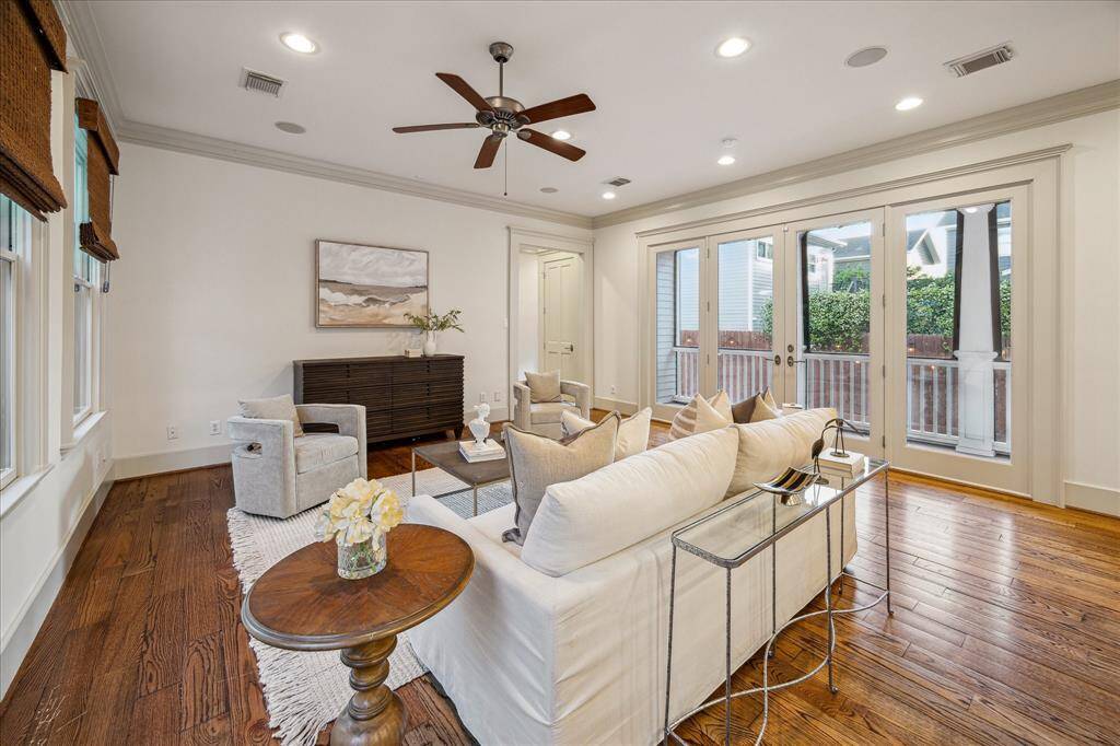 French doors opening to the screened porch and yard make grilling and gameday entertaining effortless.