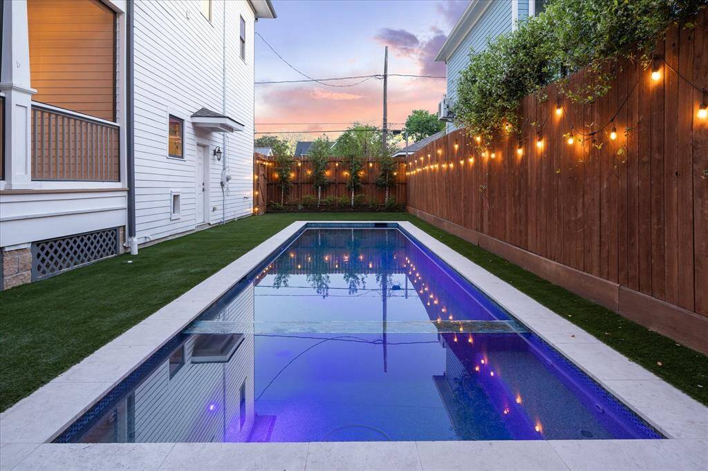 A new turf lawn and twinkle lights run throughout the spacious, fully fenced side yard.