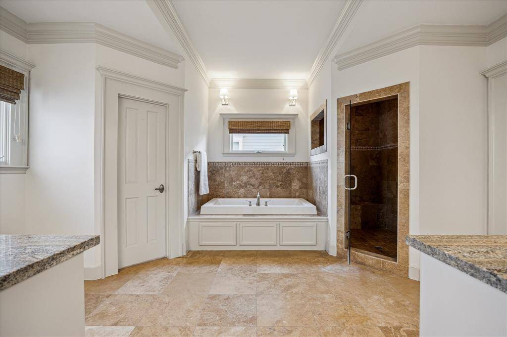 The huge primary bathroom delivers a spa-like experience with an oversized jetted soaking tub, separate shower and private water closet.
