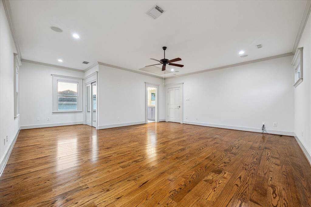 A roomy closet, ceiling fan and triple exposures complete this extra-large secondary suite.
