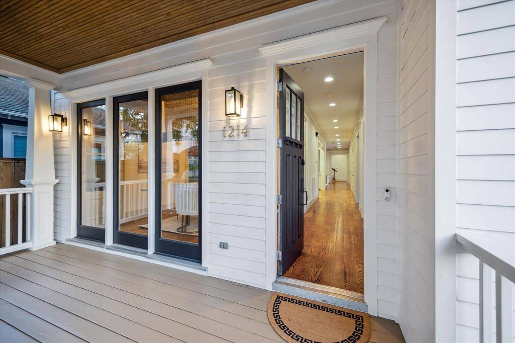 Spend breezy afternoons on this lovely, oversized front porch featuring designer lighting.