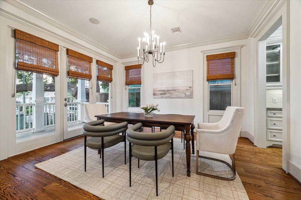 To the left of the foyer, a decorative chandelier illuminates the spacious formal dining room.