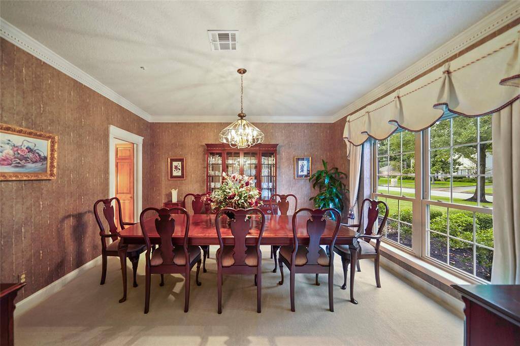 Elegant dining room with large windows offering plenty of natural light.