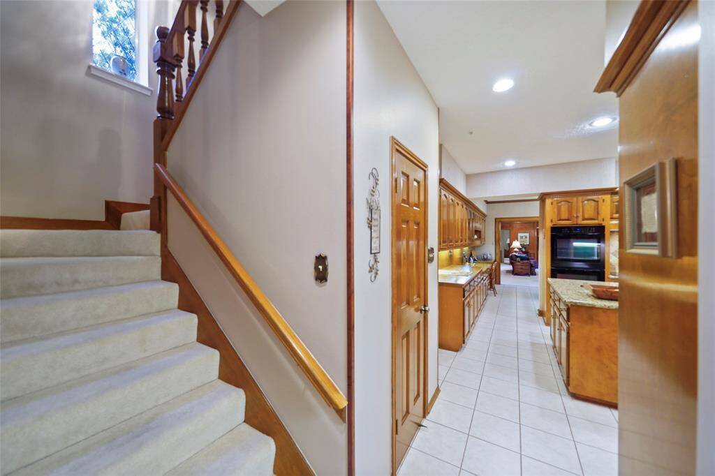 Additional staircase from kitchen leads up to the massive gameroom and the 4 upstairs bedrooms. Great charm and functionality.